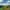 Small camping tent in a mountainous landscape.