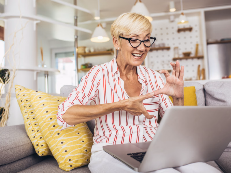 Woman communicating via webcam using hand gestures