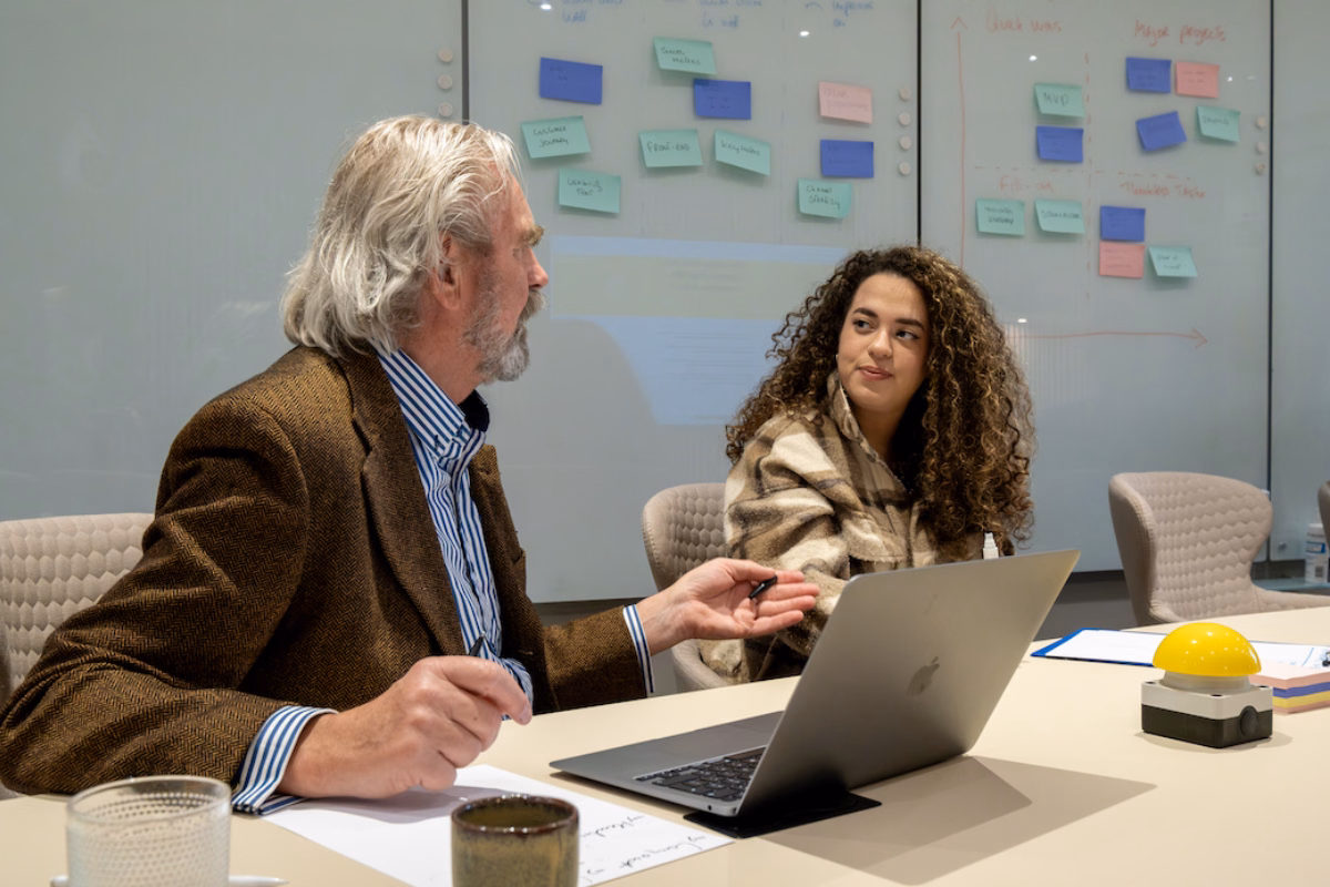 Two people discussing ideas at a table.