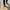 Person walking down the street with a white cane.