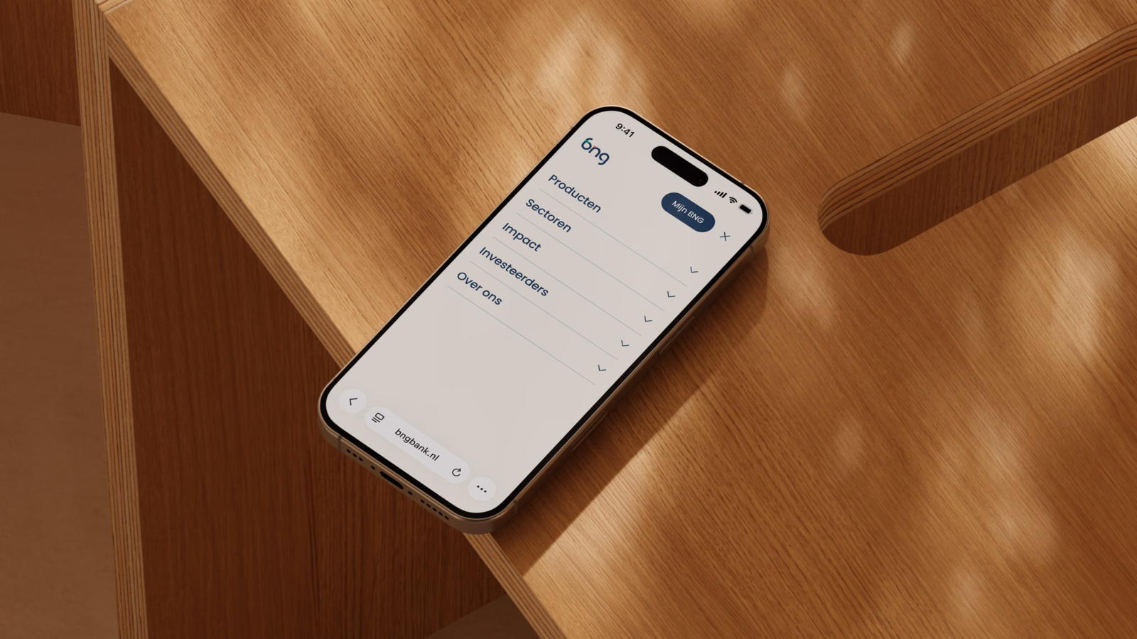 Smartphone on table showing the menu of the new BNG site